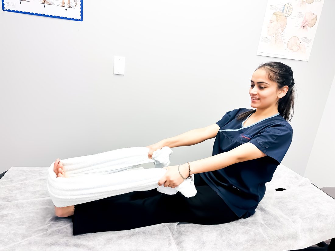 Towel stretch for shoulder and rotator cuff mobility at Platinum Physiotherapy Brampton — registered physiotherapist guided exercise